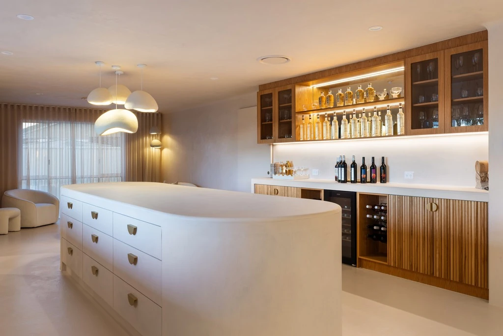 Custom dark timber bar and kitchen joinery with stone detailing
