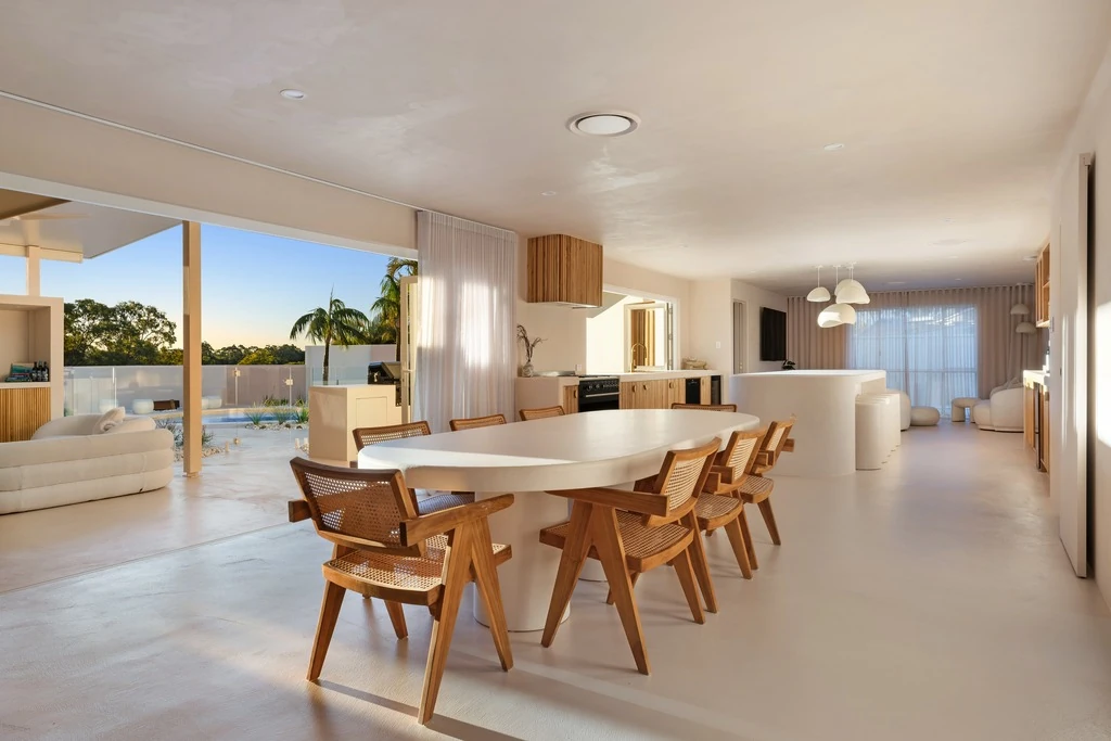 Open-plan dining space connected to a landscaped courtyard