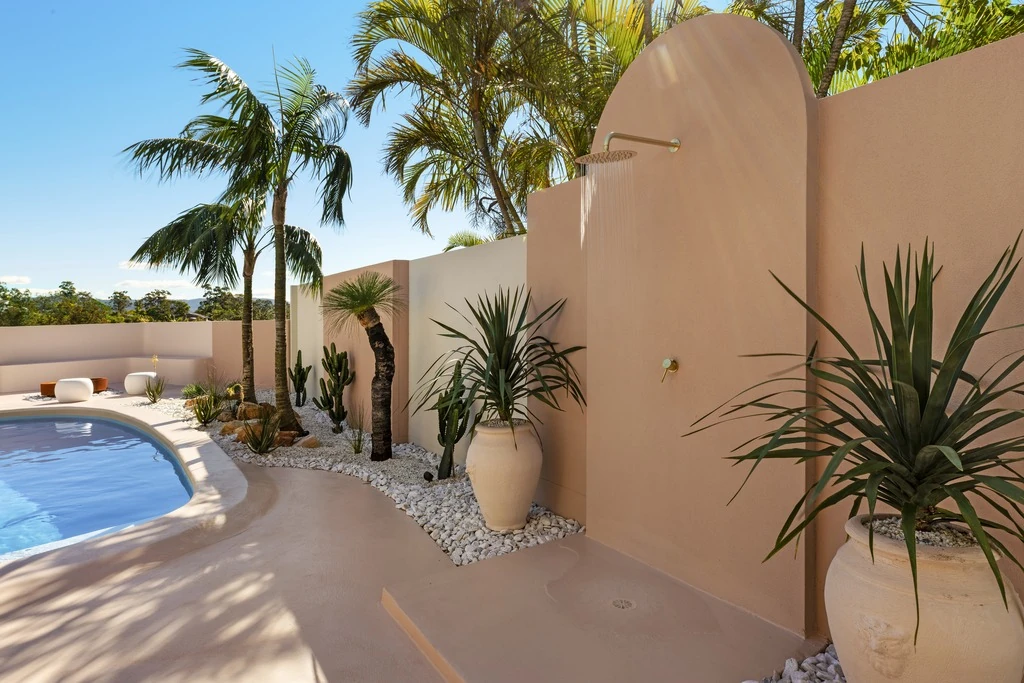 Sculptural courtyard and swimming pool framed by curved architecture